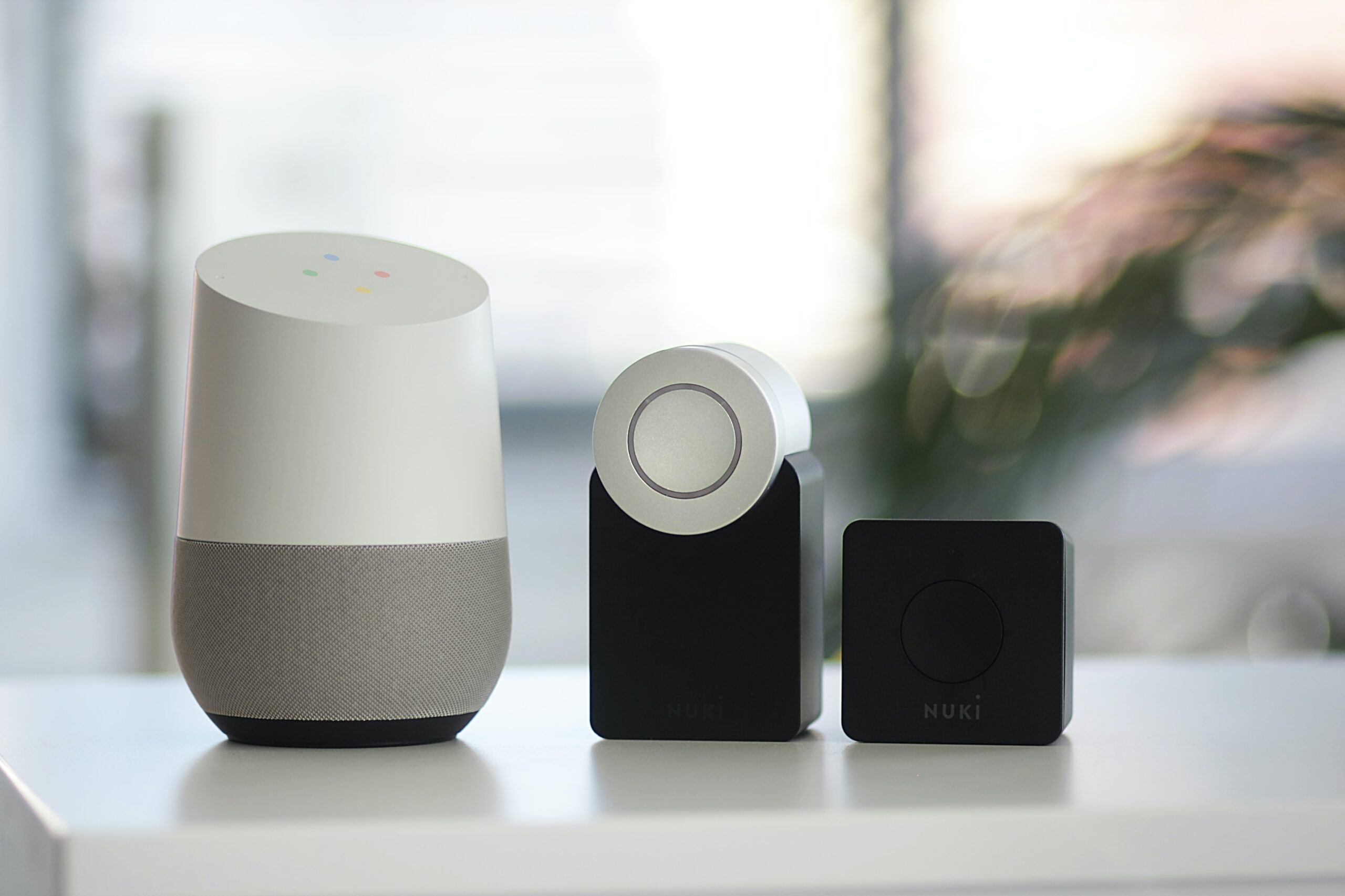 Choose-Wisely-What-Smart-Home-Tech-Should-You-Adopt-and-Avoid-scaled.jpg white and gray Google smart speaker and two black speakers